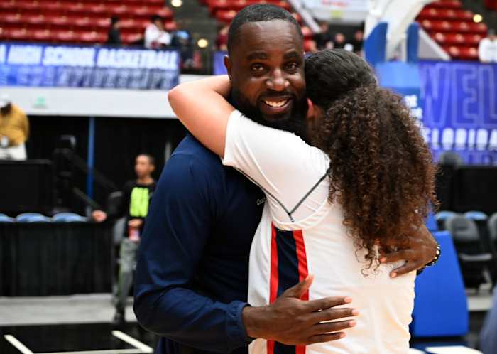 Miami Country Day head coach Ochiel Swaby is hugged by Kayla Nelms after the team won back-to-back Class 3A state championships at the RP Funding Center in Lakeland on Friday.